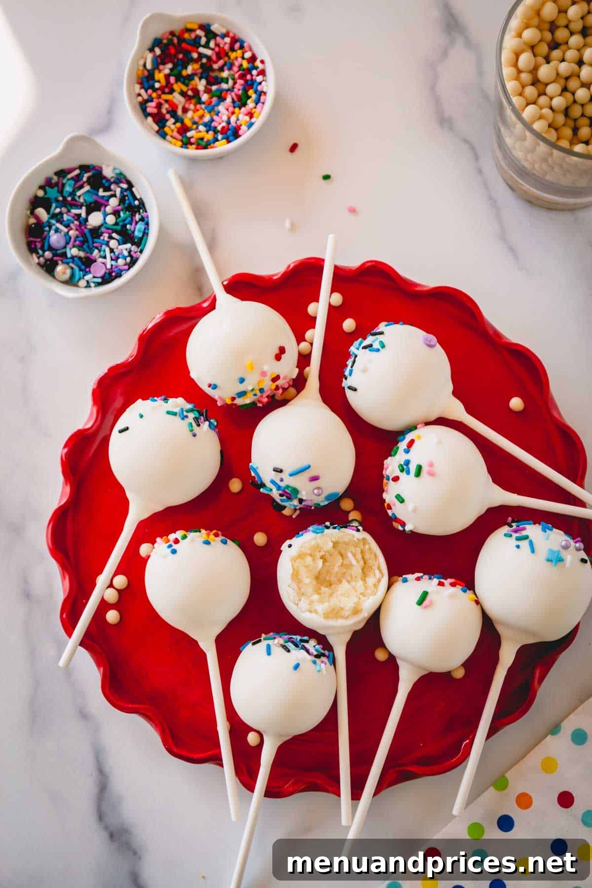 Foolproof Cake Pop Delight 3 A vibrant display of cake pops with sprinkles arranged on a festive red plate.
