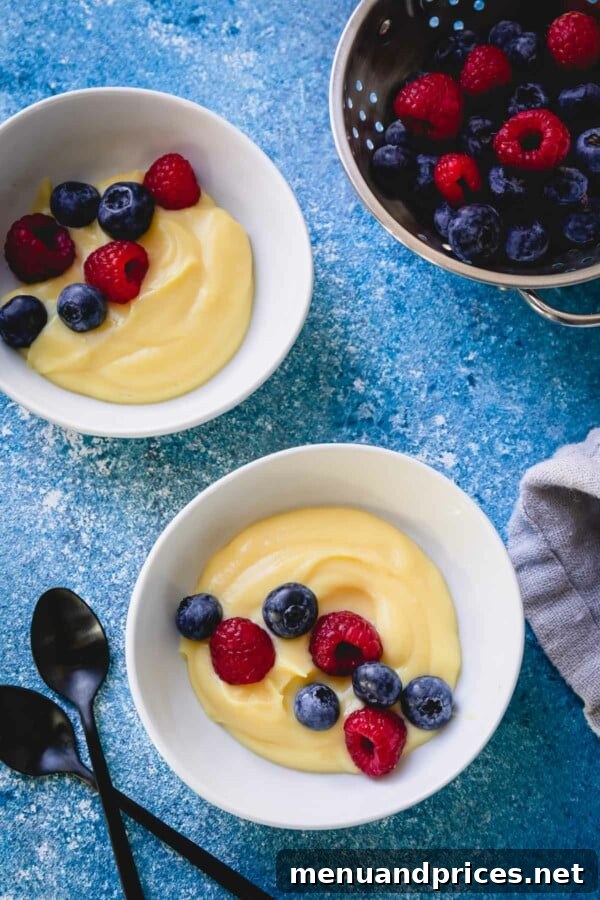 Mastering Classic French Pastry Cream 14 Overhead shot of 2 small bowls of pastry cream topped with fresh berries.