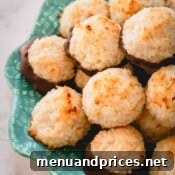 Ultimate Coconut Macaroons 13 A plate of chocolate-dipped coconut macaroons, tempting for a treat.