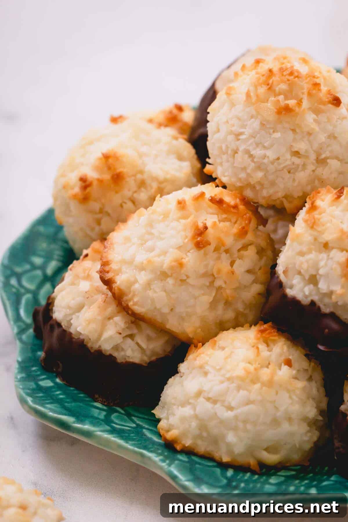 Ultimate Coconut Macaroons 10 A beautifully arranged plate of chocolate-dipped macaroon cookies, ready to be served.