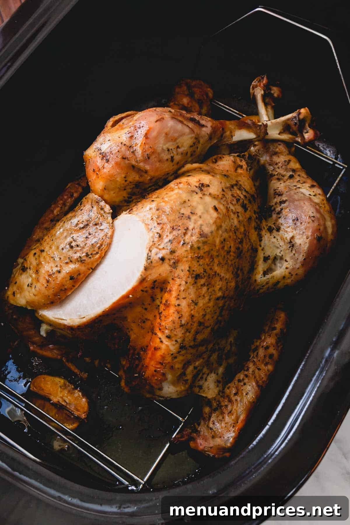 Roasted turkey in an electric roaster, perfectly golden.