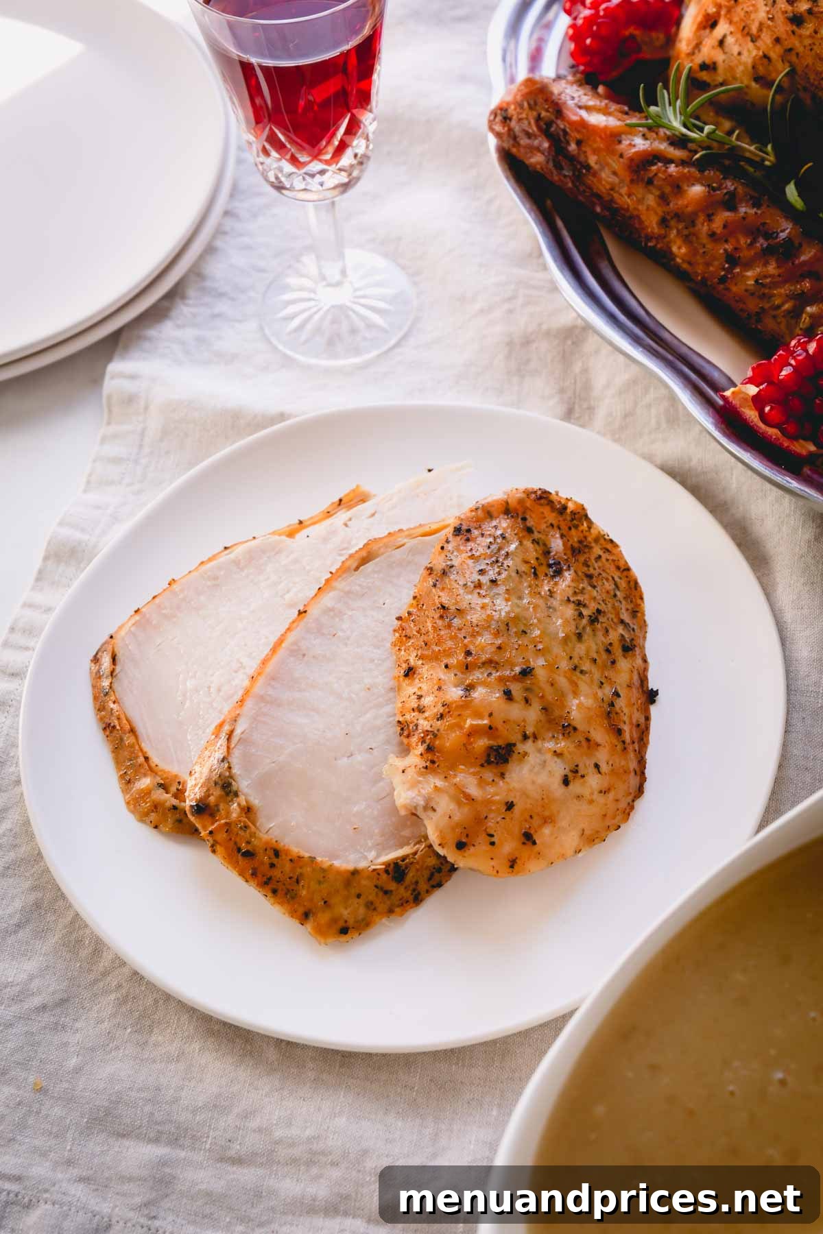 Three perfectly sliced turkey breast pieces on a small white plate, showcasing juiciness.