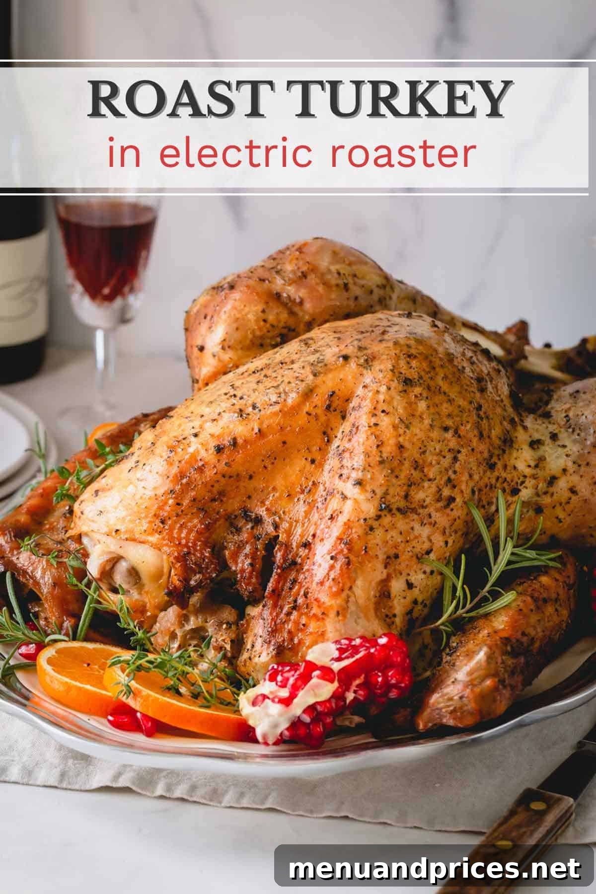 A roasted turkey on a serving platter garnished with orange, pomegranate and fresh rosemary, ready for the table.