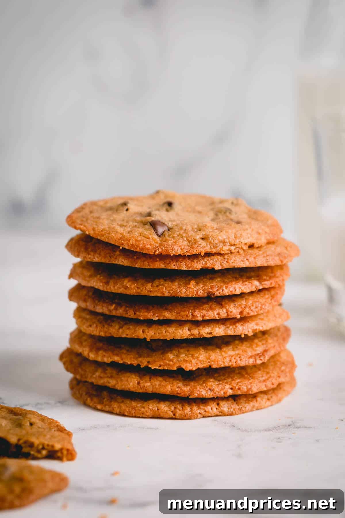 Golden Crunch Chocolate Chip Delights 3 A beautifully arranged stack of thin chocolate chip cookies, showcasing their uniform golden color and delicate texture.