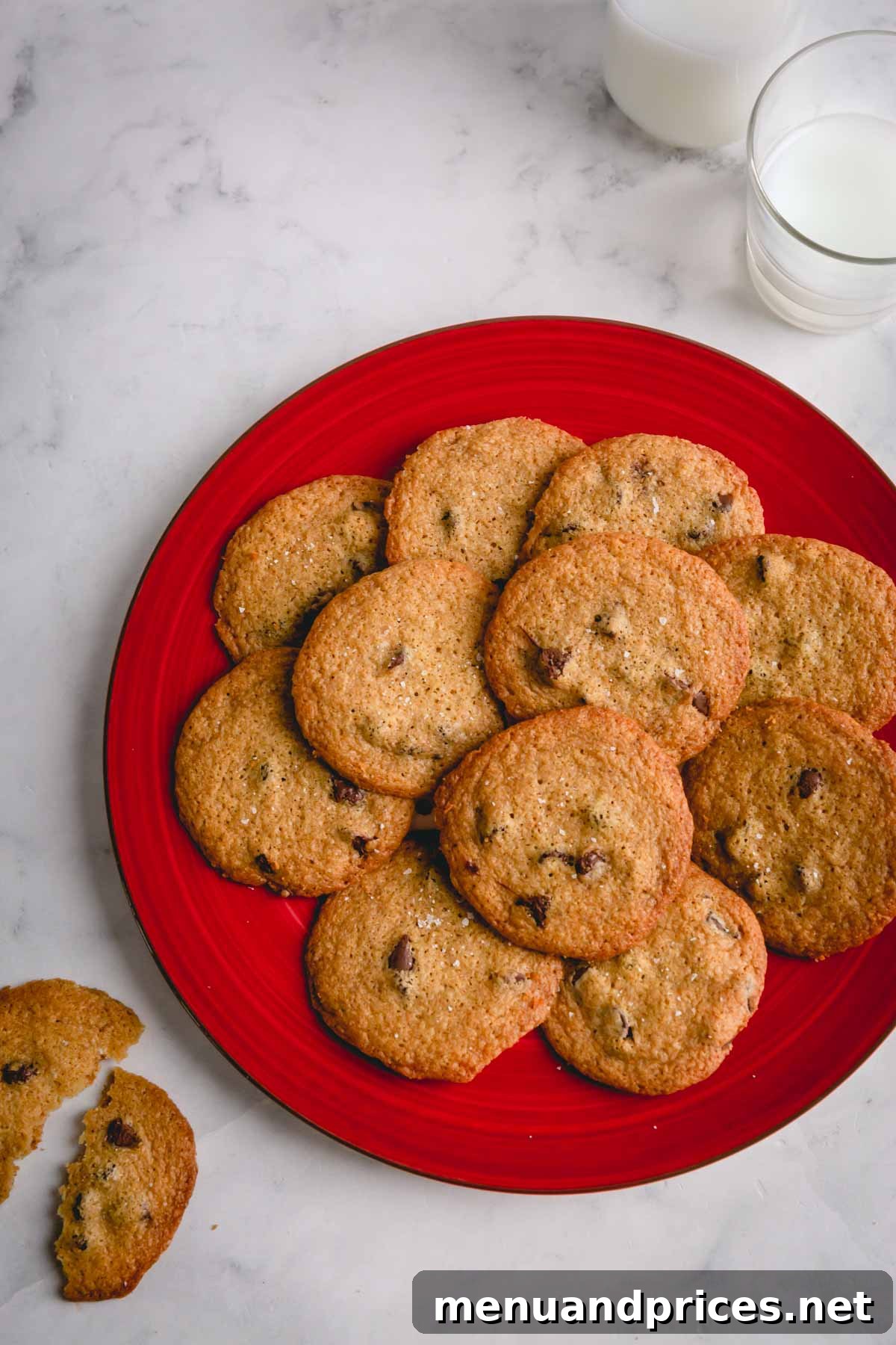 Golden Crunch Chocolate Chip Delights 10 A rustic plate filled with an abundance of thin chocolate chip cookies, artfully arranged and ready to be enjoyed.