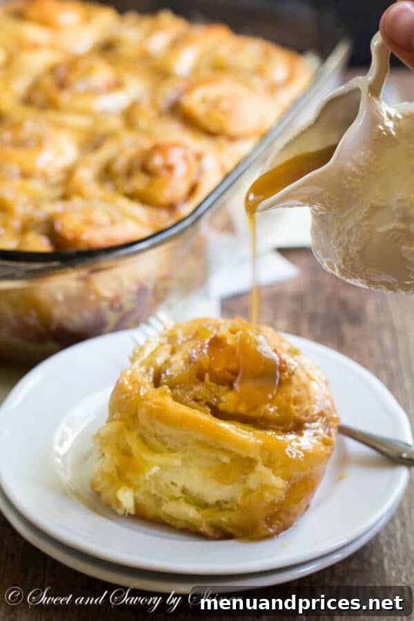 Apple Spice Swirls 3 A close-up shot of an individual apple cinnamon roll, showcasing its fluffy interior and luscious caramel topping, ready to be enjoyed.