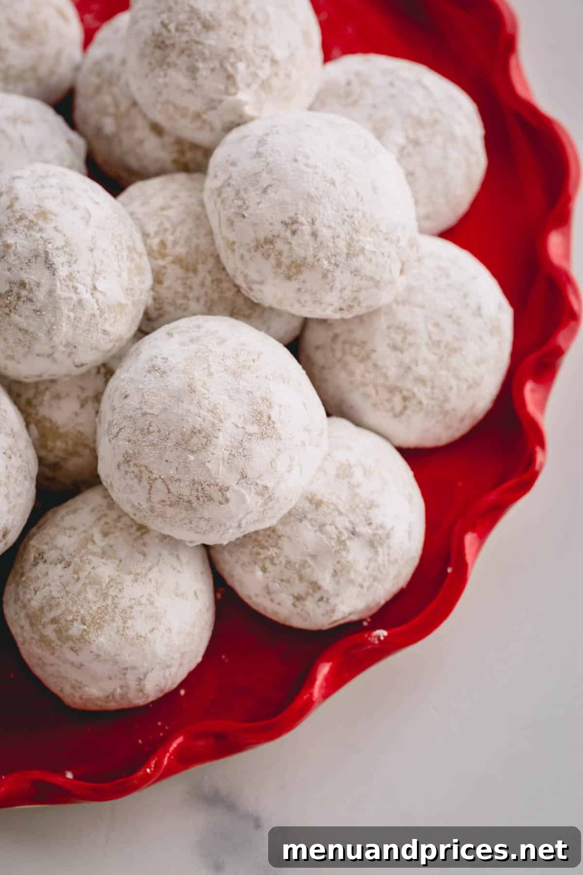 Buttery Pecan Snowball Cookies 2 A beautiful plate of classic snowball cookies, glistening with powdered sugar.