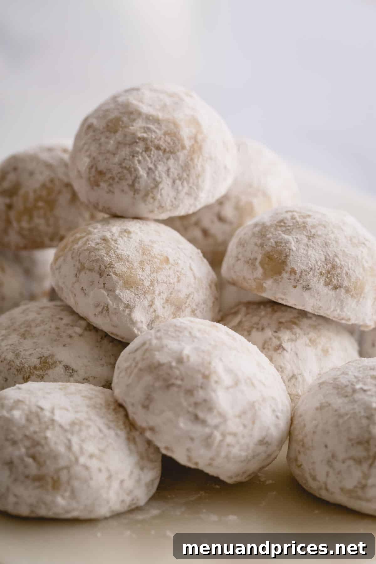 Buttery Pecan Snowball Cookies 15 A charming stack of snowball cookies, lightly dusted with powdered sugar.