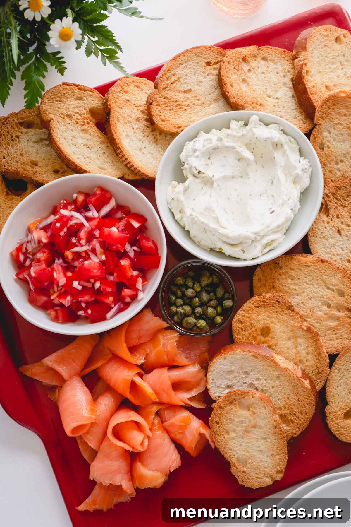 Artisan Smoked Salmon Crostini 6 A beautifully presented platter featuring all the components for assembling smoked salmon crostini: toasted bread, bowls of cream cheese and tomato relish, and elegant slices of smoked salmon.