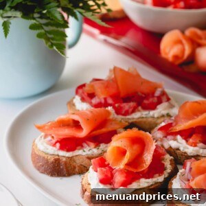 Artisan Smoked Salmon Crostini 8 Assembled smoked salmon crostini on a white serving platter, shown in a recipe card context.