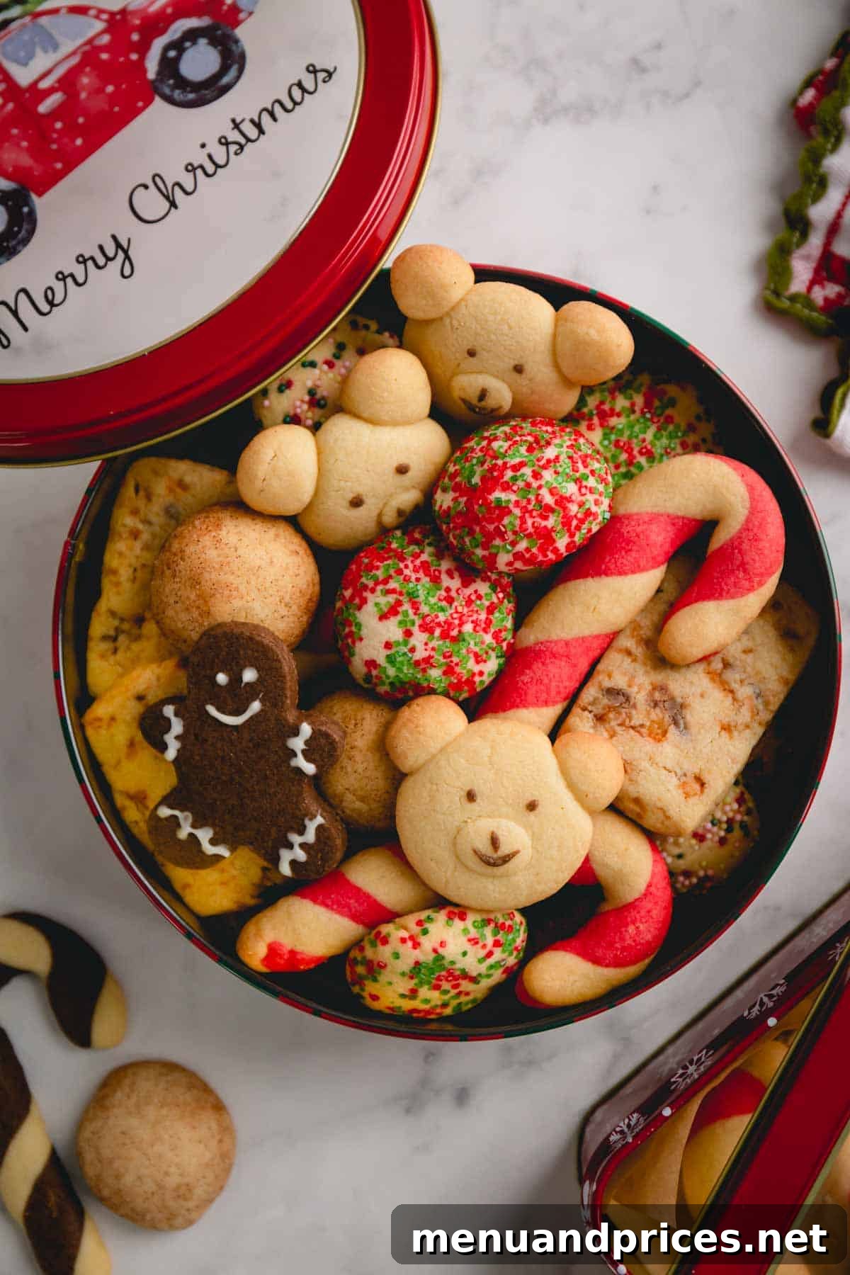 A round tin can of assorted Christmas butter cookies, perfect for gifting or storage.