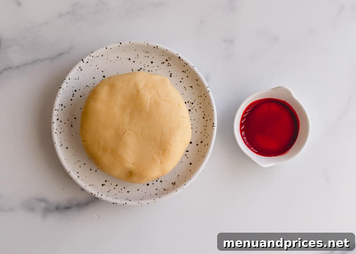 Cooking dough ball and red food coloring, ingredients for candy cane cookies.