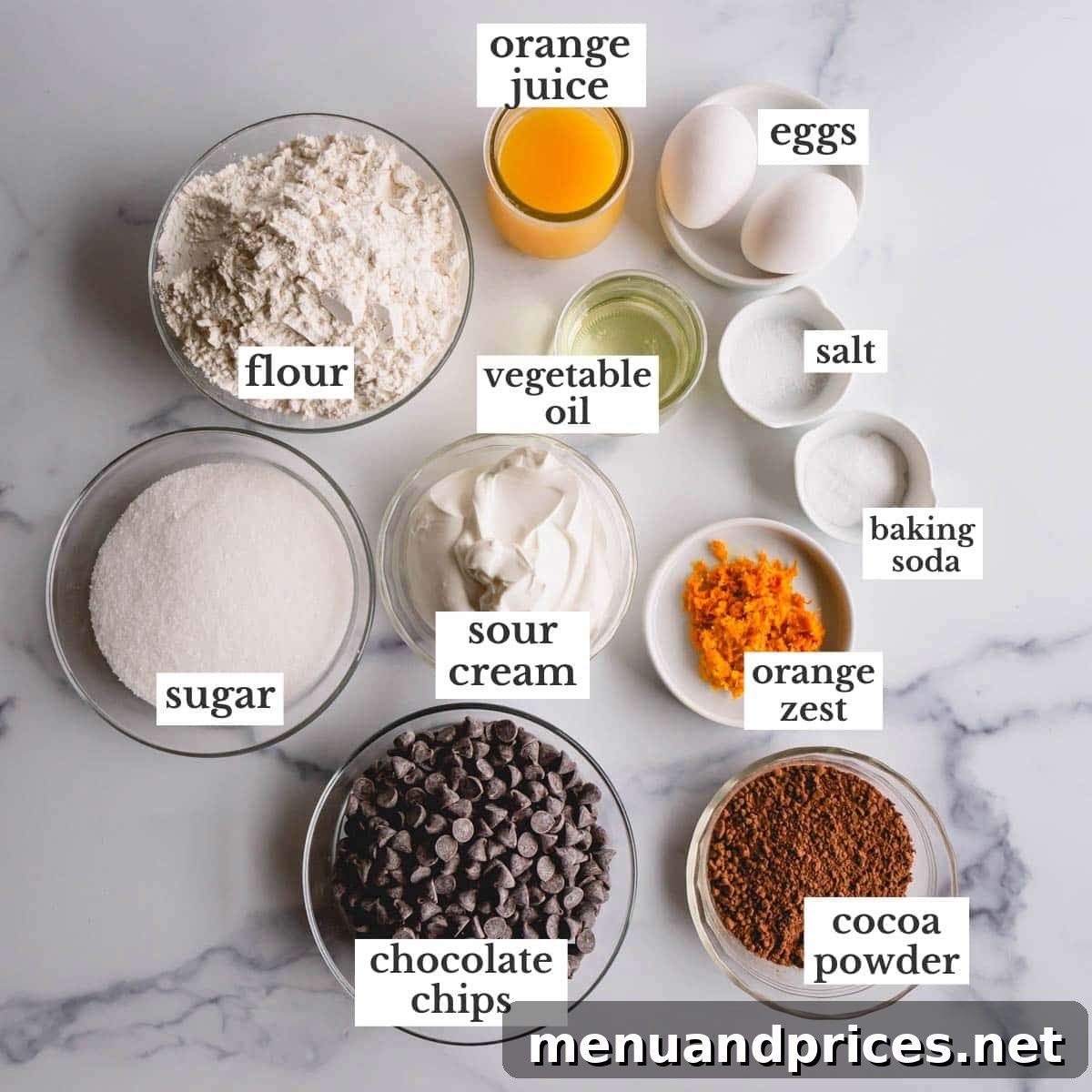 Zesty Orange Chocolate Delights 4 All the fresh ingredients laid out on a table, ready for baking delicious orange chocolate muffins.