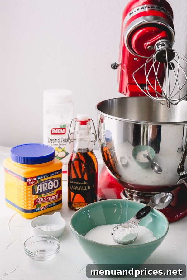 Effortless Pavlova Perfection 5 A flat lay of simple Pavlova ingredients including egg whites, sugar, cornstarch, cream of tartar, and vanilla extract, emphasizing ease. #Pavlovacakeingredients