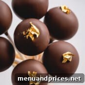 Crafting Perfect Chocolate Cake Pops From Scratch 13 chocolate cake pops with gold luster.