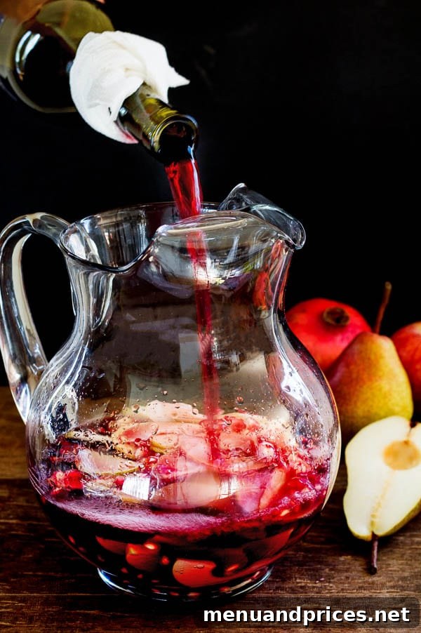 Harvest Sangria 4 This easy party drink recipe showcases a vibrant Fall Sangria, infused with succulent fall fruits like apples, pears, and pomegranates, resulting in a bright, crisp, and slightly sweet flavor profile.