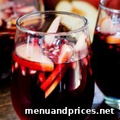 Harvest Sangria 7 A close-up of a glass of Fall Sangria, showcasing the vibrant red wine and fresh autumn fruits.