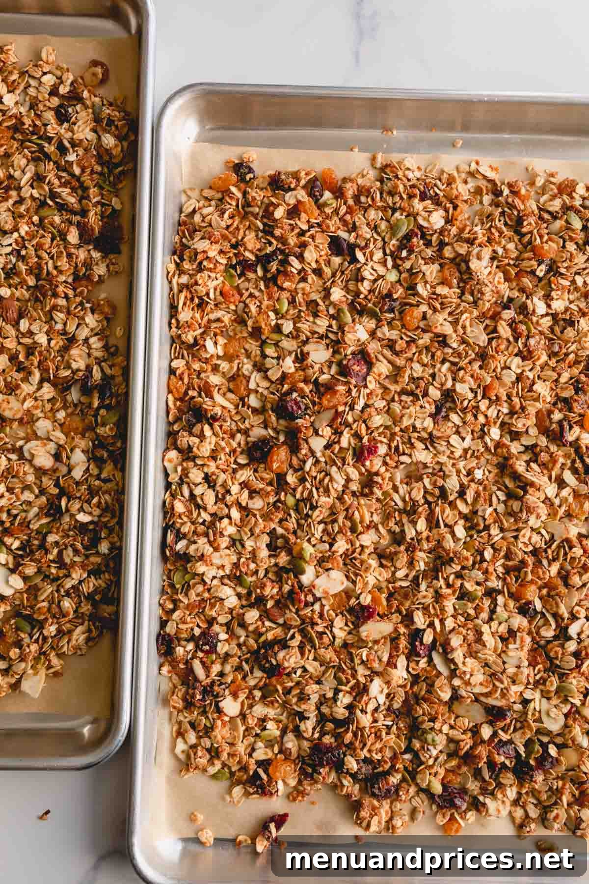 Wholesome Almond Crunch Granola 7 A baking sheet filled with freshly baked, golden-brown homemade almond granola, spread evenly for cooling.