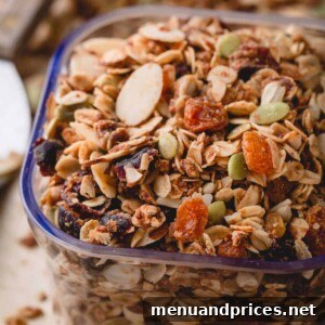 Wholesome Almond Crunch Granola 8 A scoop of homemade almond granola with dried fruit, ready to serve.