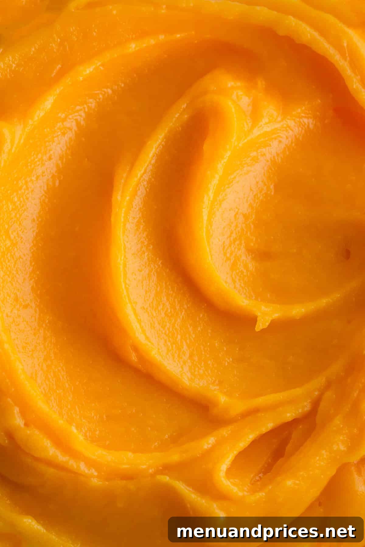Tangy Pineapple Curd 3 Close up shot of the vibrant yellow pineapple curd in a glass container.