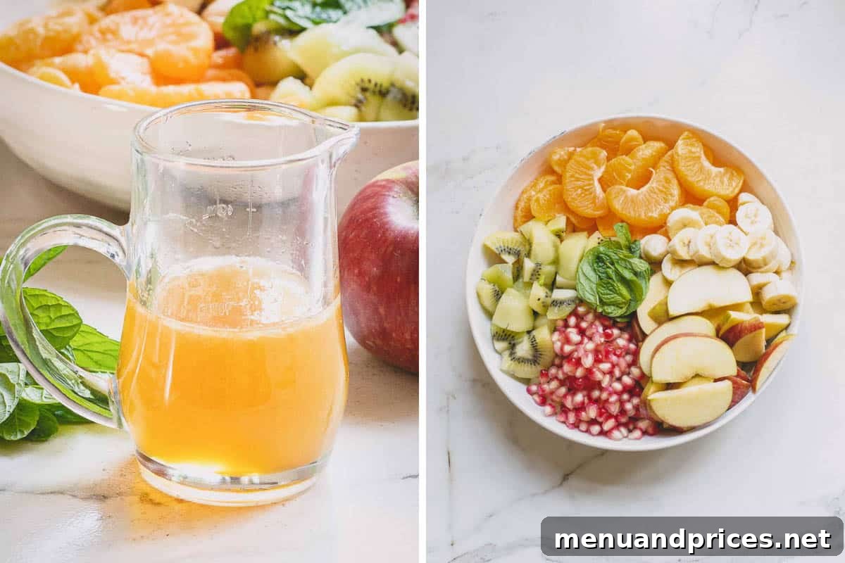 A small glass jar of honey lime dressing next to a large bowl filled with various cut fruits, ready to be combined.