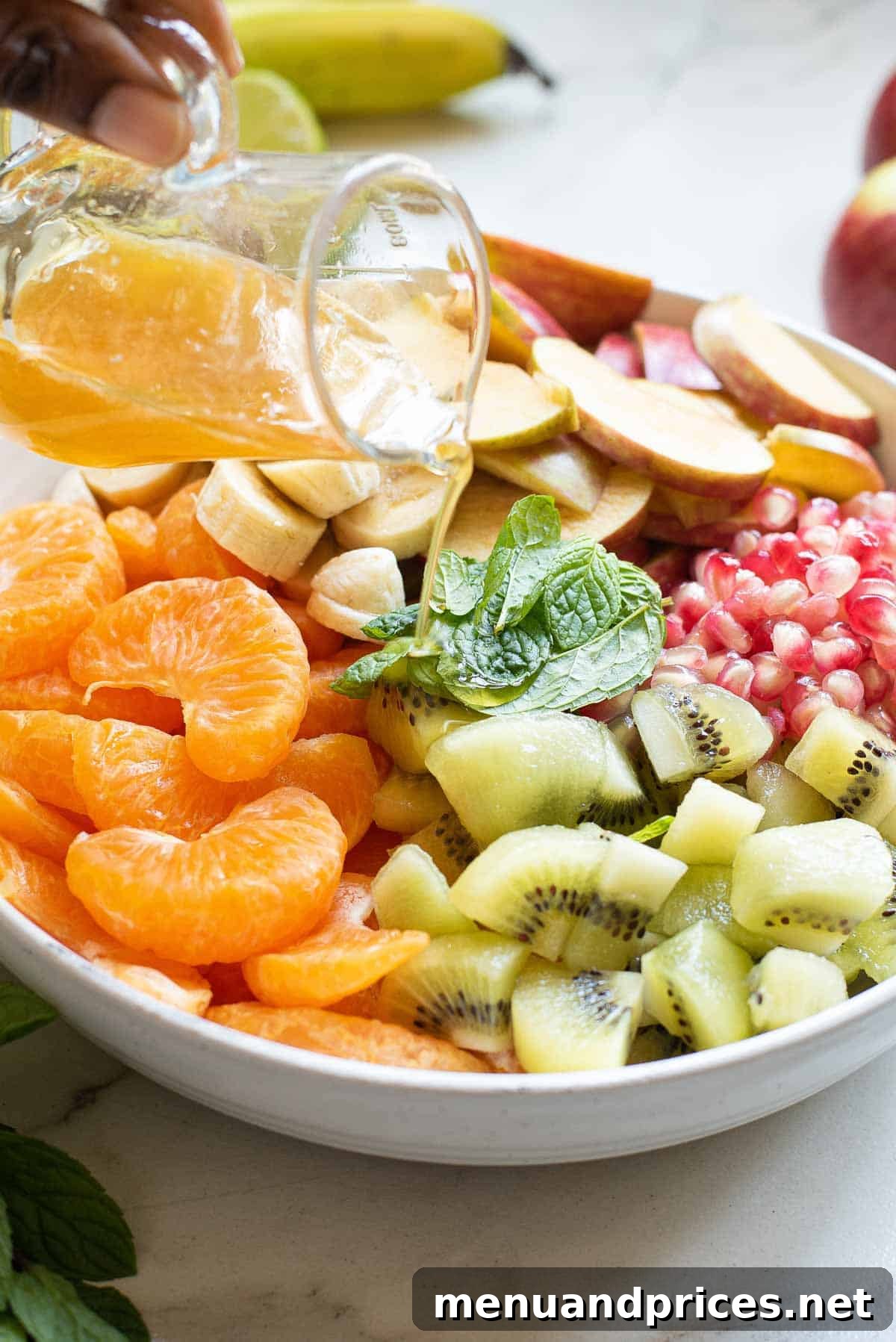 A close-up shot of a vibrant bowl of fresh fruit salad, showing the detailed textures and colors of the mixed fruits.