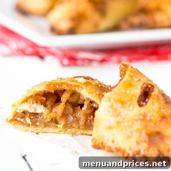 Flaky Apple Pie Delights 5 An apple pie turnover sliced in half, revealing the warm, spiced apple filling and flaky crust.