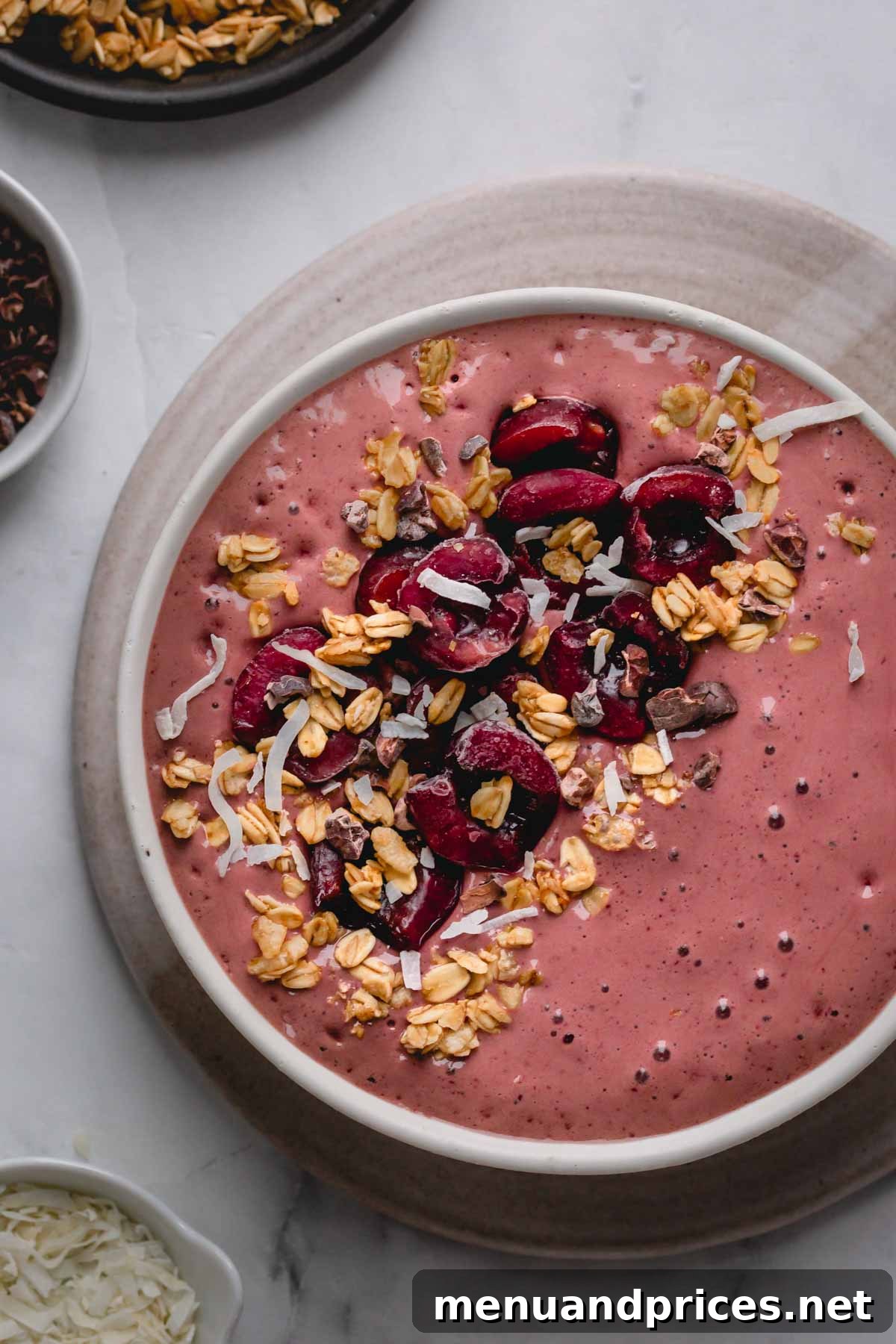 Black Forest Bliss Bowl 5 A beautifully prepared black forest smoothie bowl garnished with fresh cherries on top, ready for serving.
