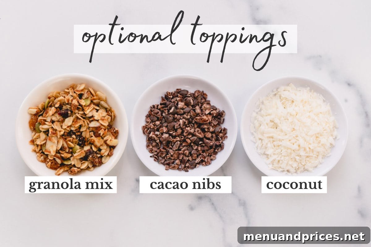 Black Forest Bliss Bowl 6 A selection of delicious smoothie bowl toppings: granola, cacao nibs, and shredded coconut, artfully arranged.