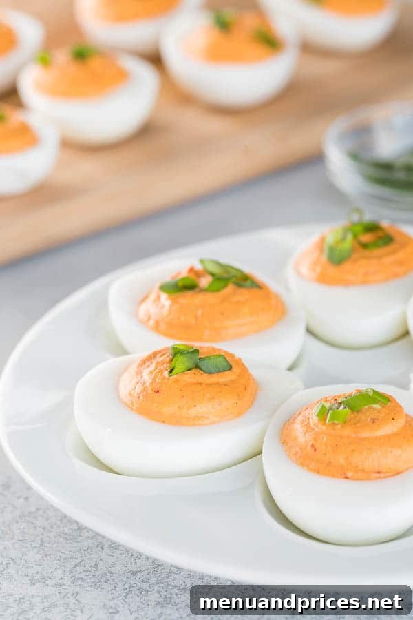 Roasted red pepper deviled eggs with ultra-smooth, creamy filling. The classic deviled egg recipe with big bold flavors and a spicy kick! #roastedredpepper #deviledeggs #easyappetizer