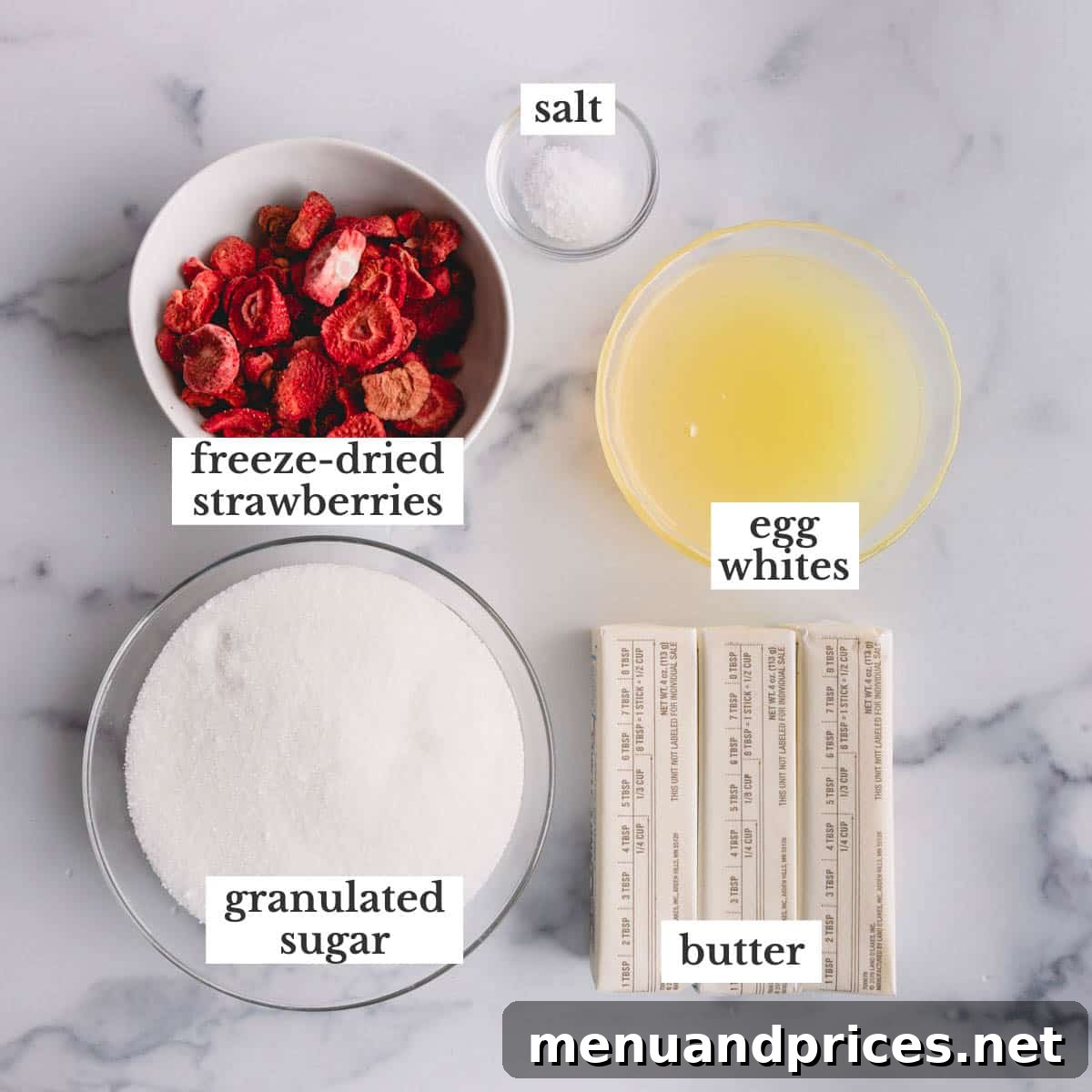 Velvet Strawberry Swiss Buttercream 3 Key ingredients laid out for strawberry Swiss meringue buttercream: granulated sugar, freeze-dried strawberries, egg whites, salt, and softened butter.