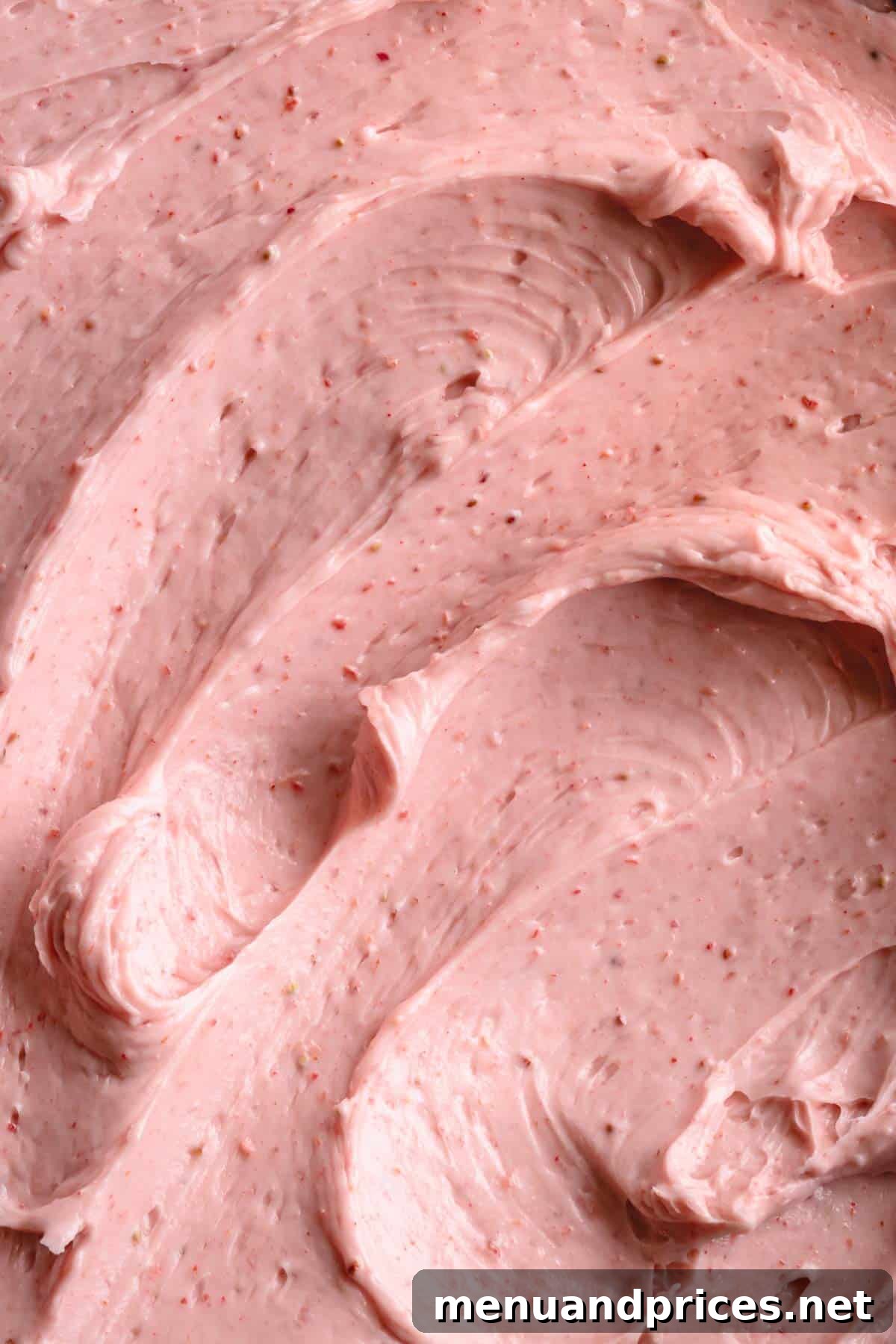 Velvet Strawberry Swiss Buttercream 8 Close-up of fluffy, perfectly piped strawberry Swiss meringue buttercream, showcasing its smooth texture.