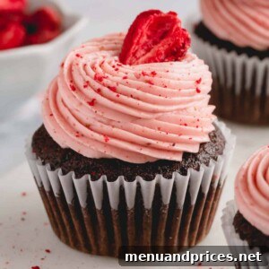 chocolate cupcake with strawberry buttercream and a strawberry.