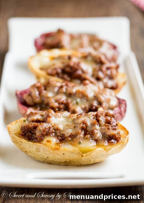 Loaded Joe Spud Boats 3 Close-up of golden brown crispy potato skins filled with hearty sloppy joe mixture and melted cheese