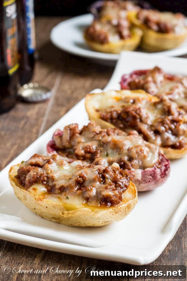 Loaded Joe Spud Boats 5 Assembled sloppy joes potato skins generously topped with shredded cheese, ready for their final bake