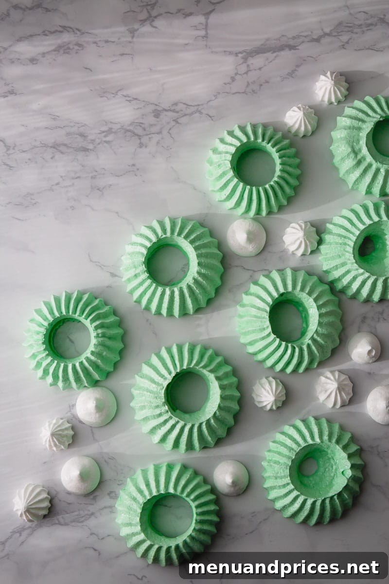 Effortless Meringue Delights 7 A delightful arrangement of baked meringue cookies in various shapes, including dots and wreaths, showcasing their light and airy texture.