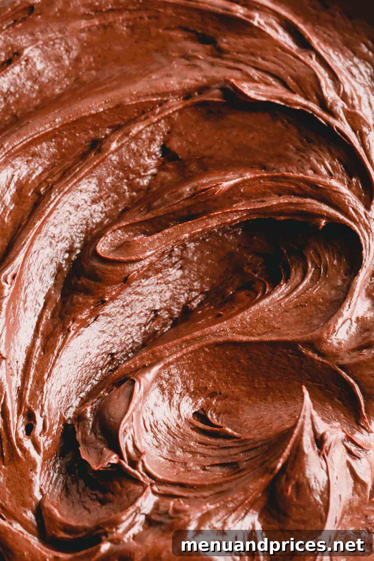 Decadent Chocolate Cream Cheese Frosting 3 Close-up shot of a bowl filled with rich, smooth chocolate cream cheese frosting, highlighting its perfect texture.