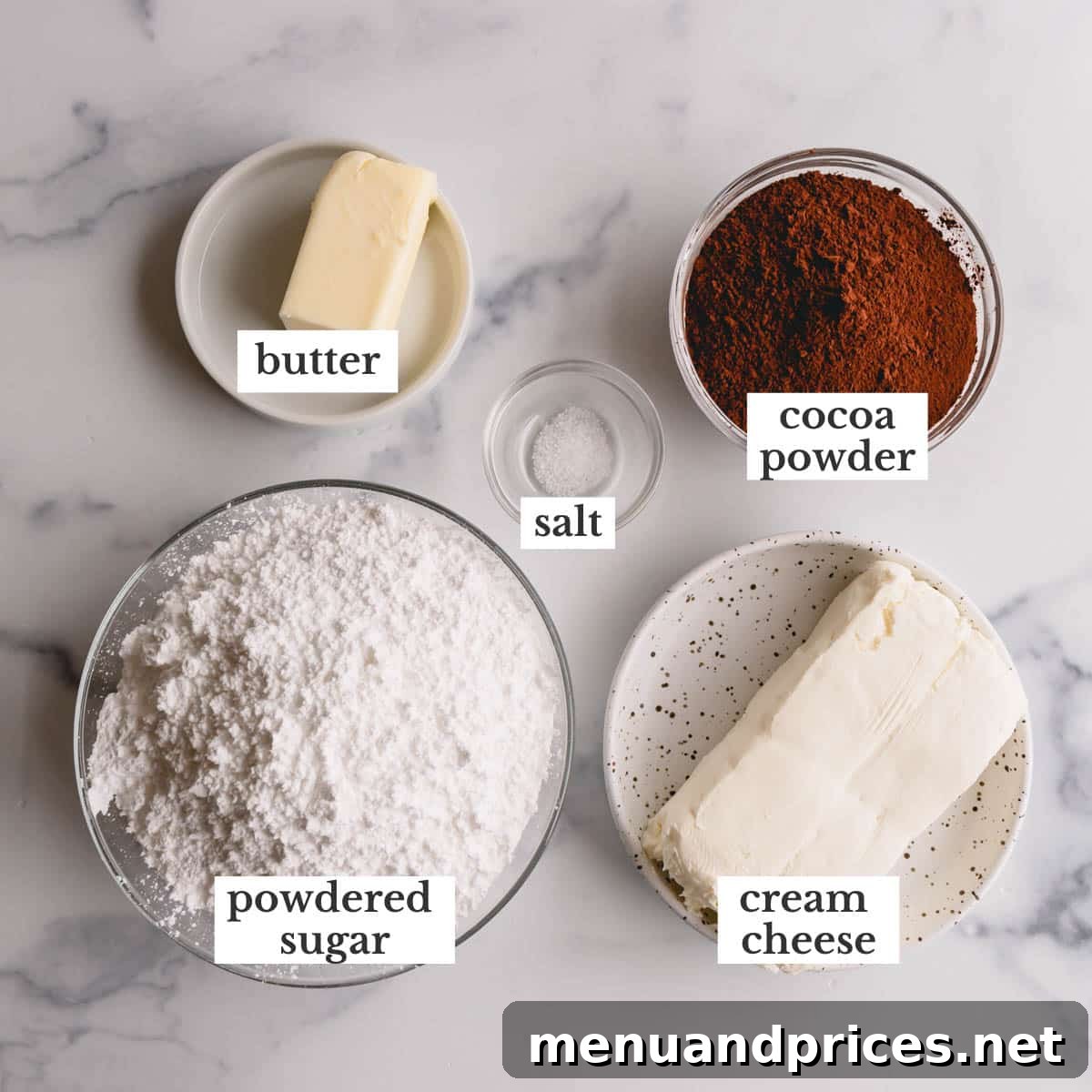 Decadent Chocolate Cream Cheese Frosting 4 A display of key ingredients: unsalted butter, full-fat cream cheese, cocoa powder, and powdered sugar, neatly arranged.