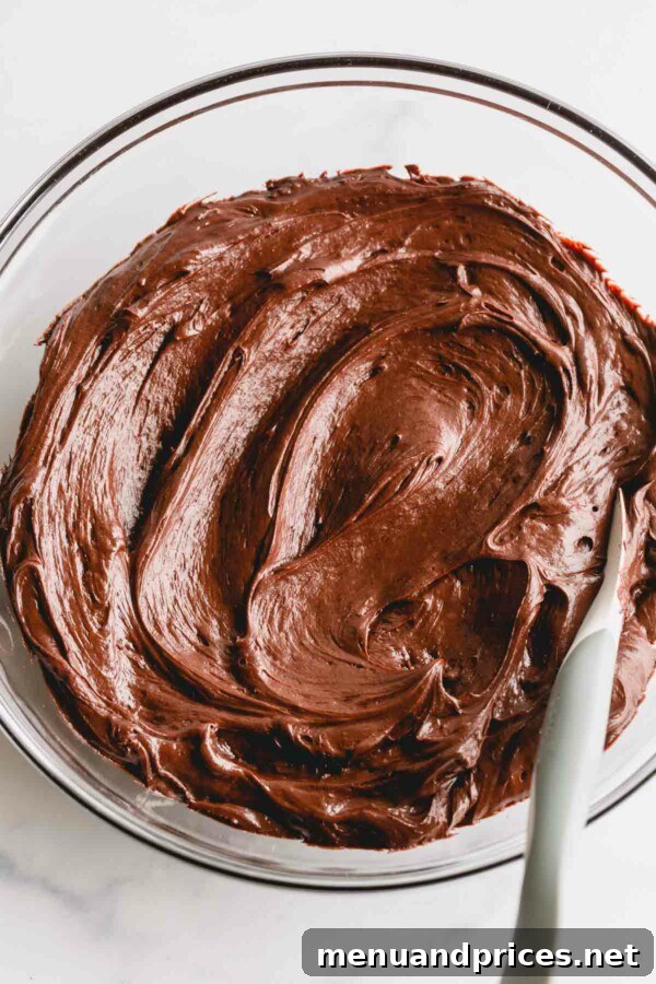 Decadent Chocolate Cream Cheese Frosting 7 A bowl of glossy, rich chocolate cream cheese icing, ready for decorating.