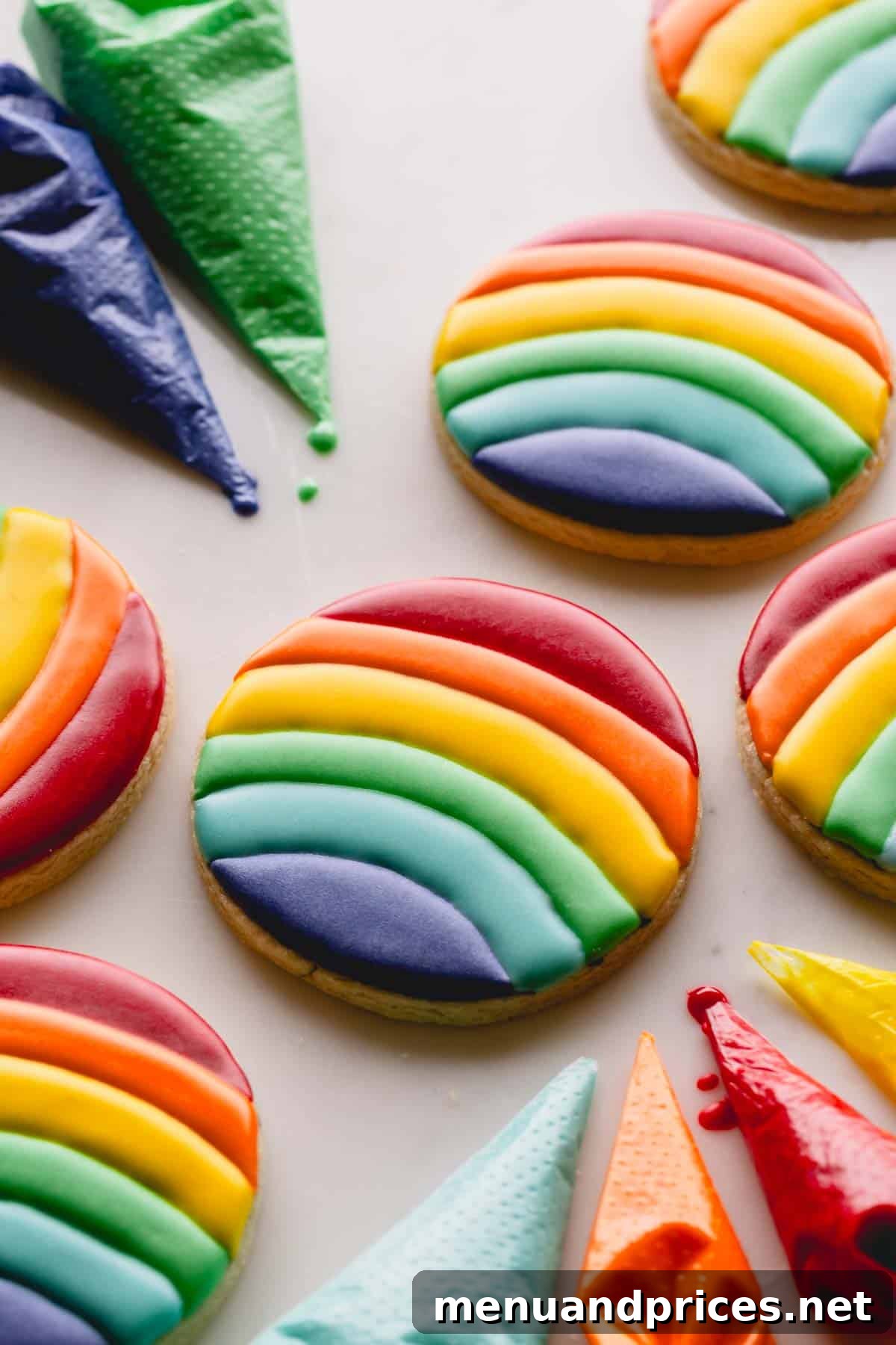 Mastering Royal Icing 13 A collection of vibrantly decorated circular sugar cookies with rainbow royal icing, showcasing the finished product.