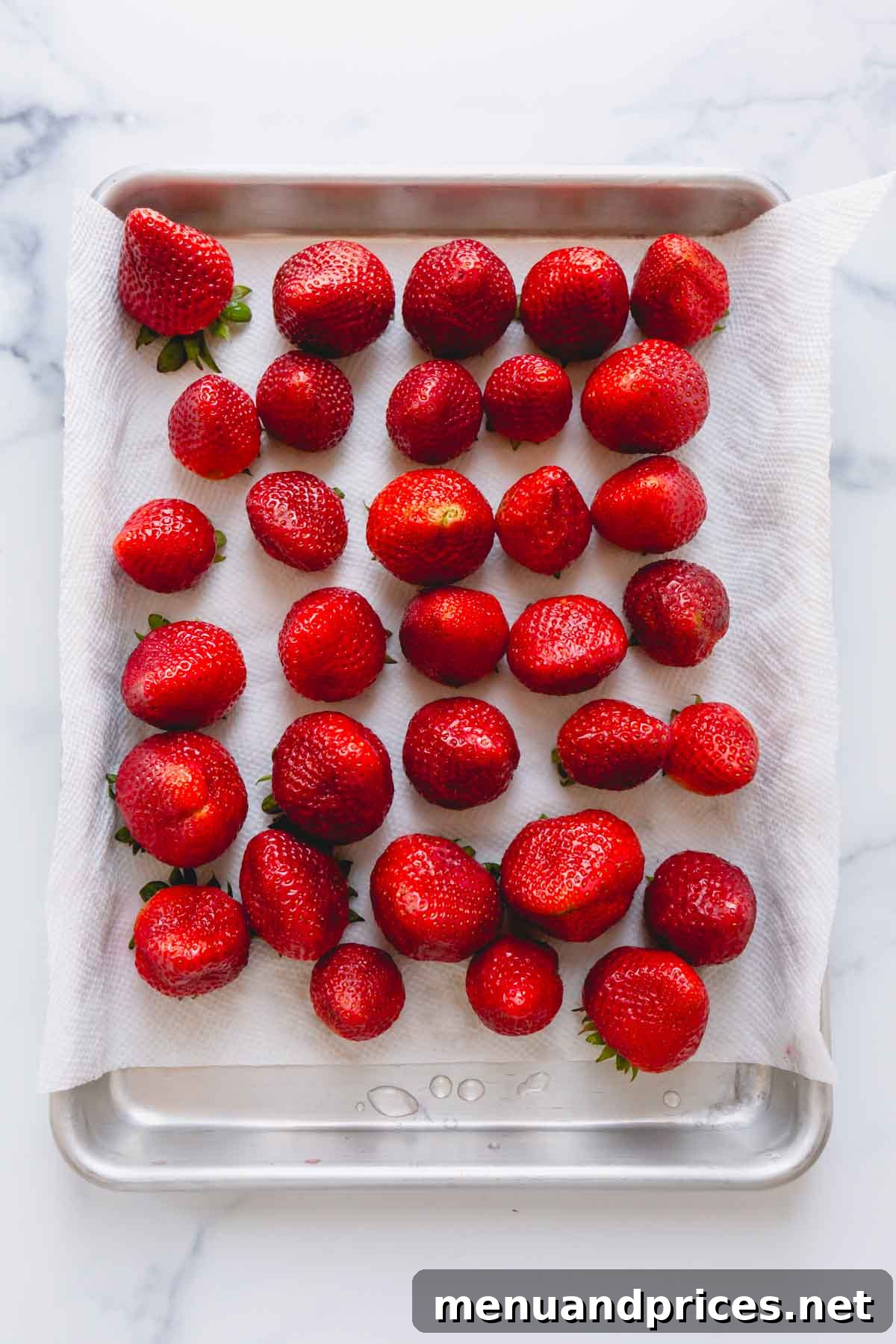 Gourmet Chocolate Strawberries 5 Clean strawberries on top of a paper towel-lined baking sheet.