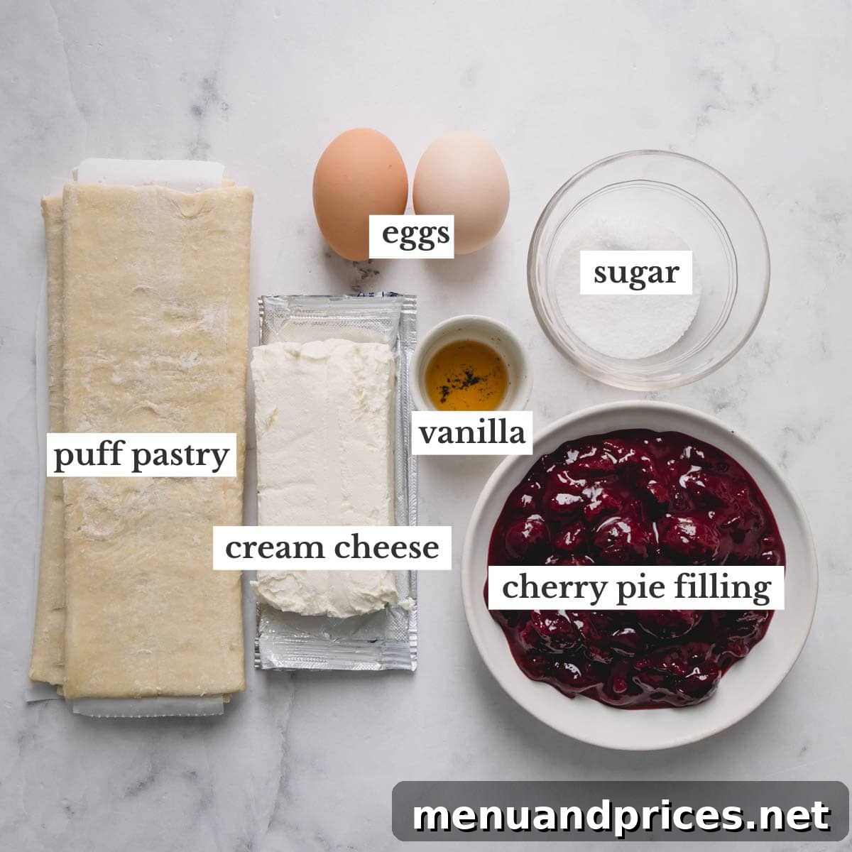 A collection of fresh ingredients, including cream cheese, eggs, and puff pastry, laid out on a clean surface, ready to be transformed into cherry cheese danishes.