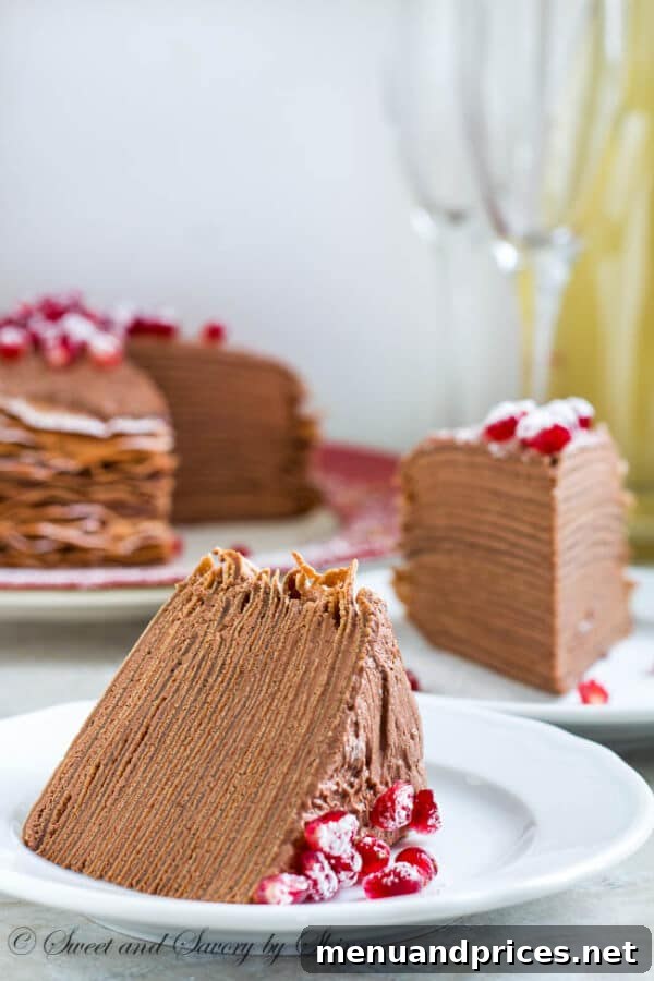 A close-up of the crepe cake, displaying the smooth, creamy texture of the chocolate mousse between each thin, perfectly cooked chocolate crepe layer.