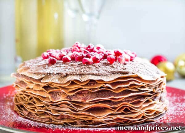 Silken Chocolate Crepe Delight 10 A wide shot capturing the full beauty of the chocolate mousse crepe cake, ready to be served, topped with a generous scattering of pomegranate seeds.