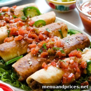 A plate of golden-brown, crispy leftover pulled pork flautas, topped with fresh pico de gallo, ready to be enjoyed.