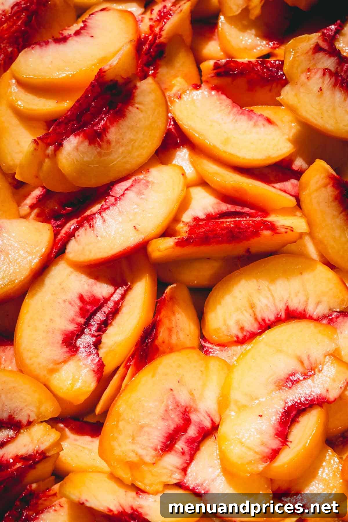 Close up image of perfectly sliced fresh peach halves, ready for the dehydrator.