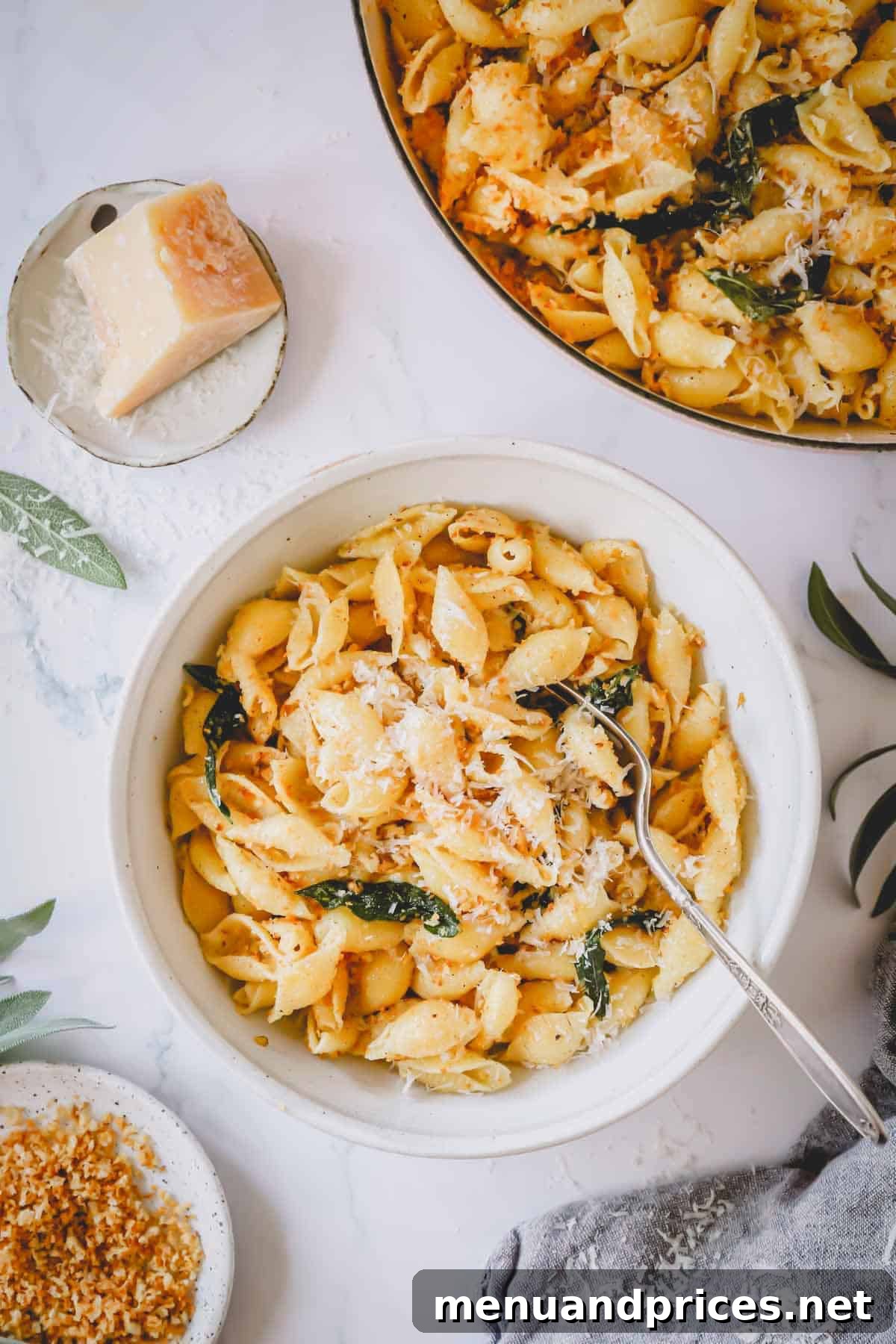 Effortless Brown Butter Pasta 9 A bowl of brown butter pasta topped generously with parmesan cheese and a fork waiting to delve in.