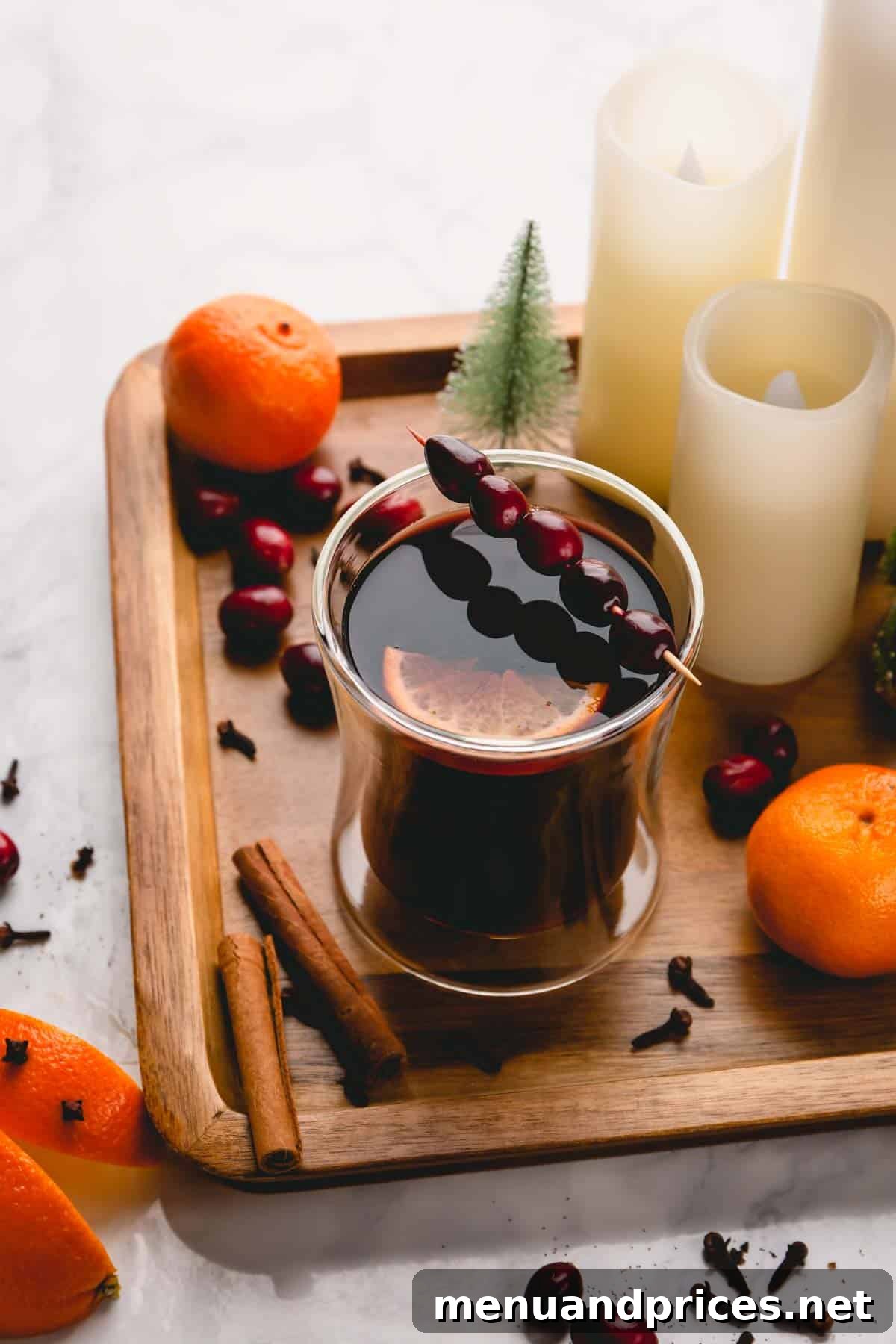 Crafting the Ultimate Mulled Wine 5 Another beautiful shot of mulled wine in a glass, adorned with fresh cranberries and a slice of orange, exuding warmth.
