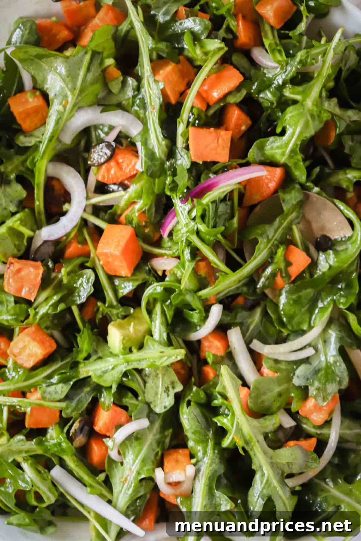 Creamy Sweet Potato Delight 3 Close-up image of a vibrant sweet potato salad elegantly dressed with a rich honey mustard vinaigrette, showcasing its fresh ingredients.