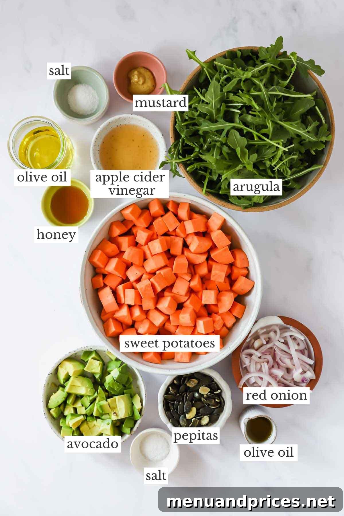 Creamy Sweet Potato Delight 4 An organized display of all fresh and wholesome ingredients required to make a sweet potato salad, alongside a jar of homemade vinaigrette.